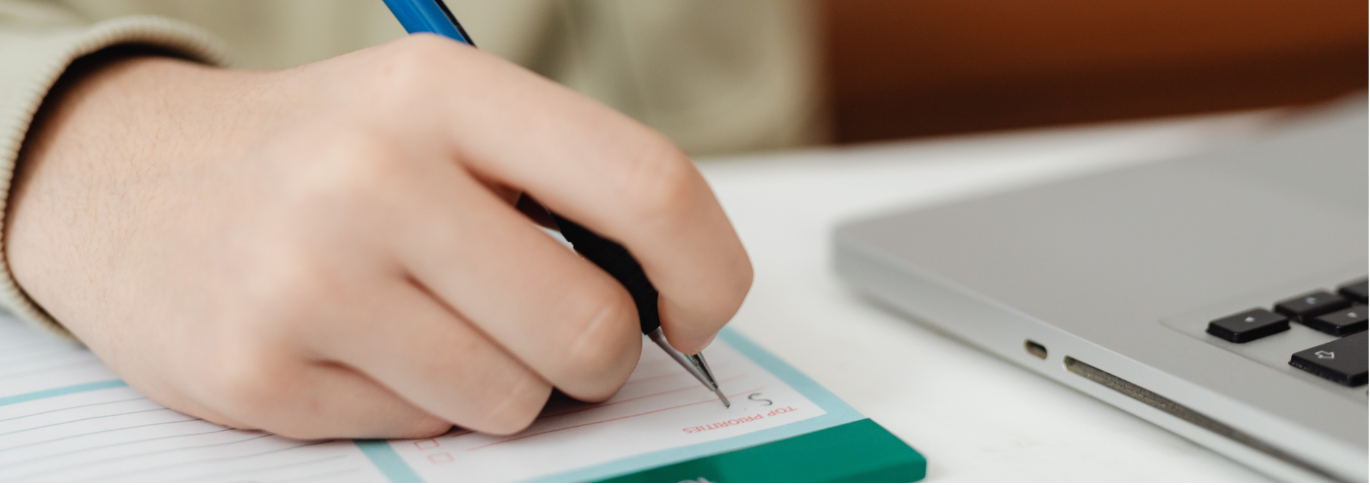 person writing on a notepad
