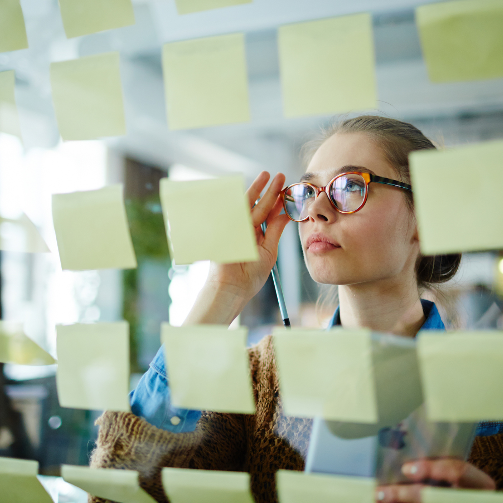 person looking at post-its