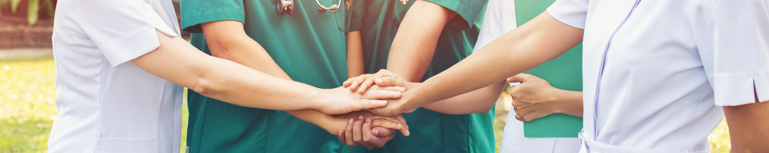 nurses and doctors with hands together