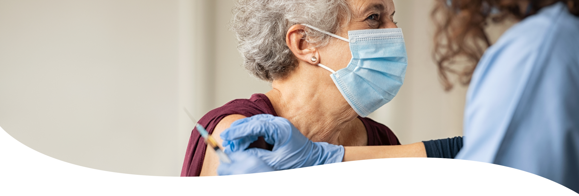 Image of a lady receiving the vaccine